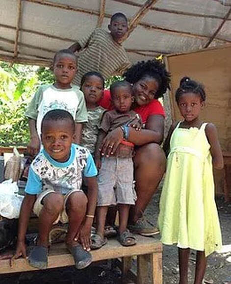 photo of teacher and her students at Rodaille Haiti